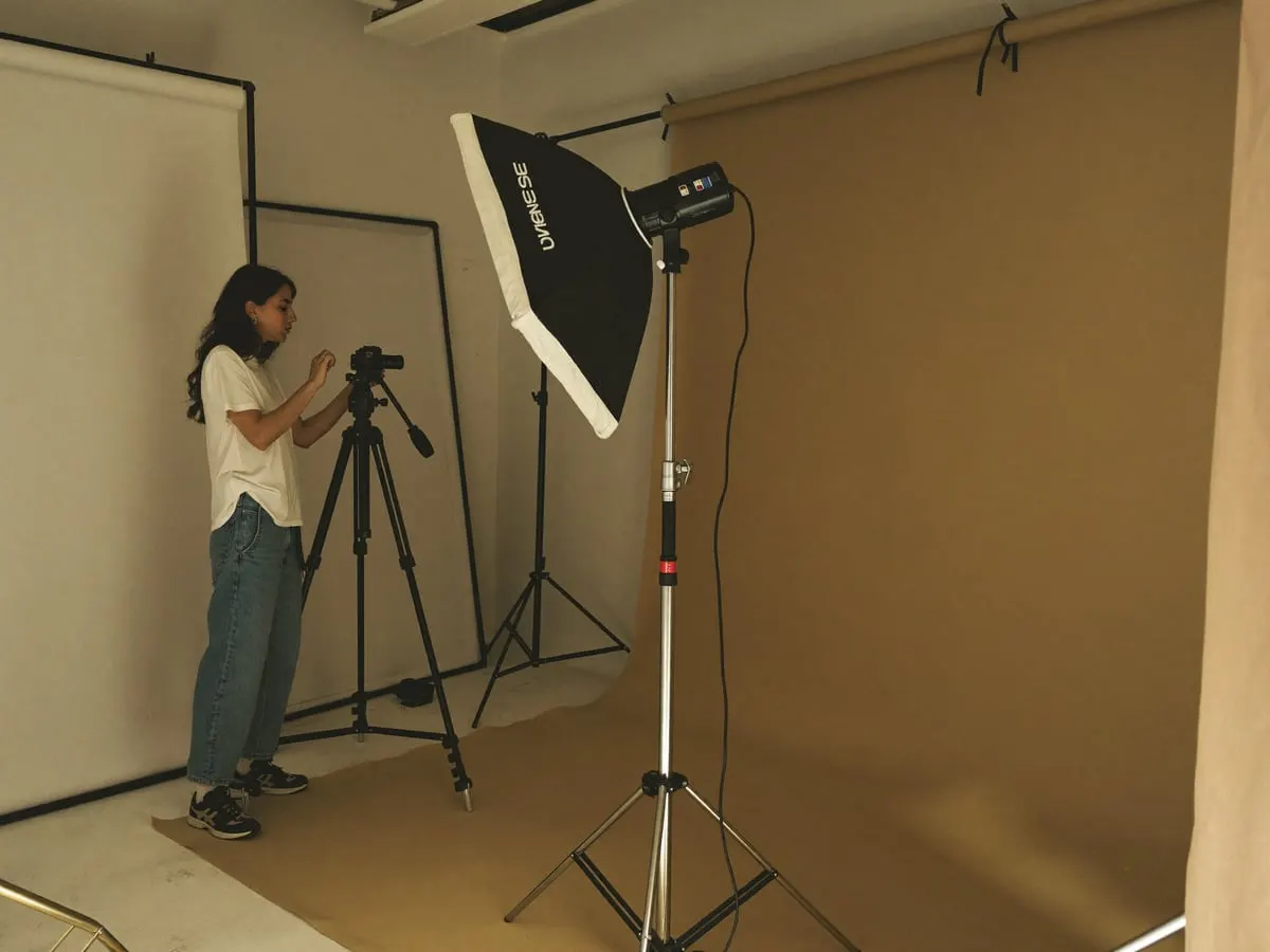 A photographer setting up a softbox
